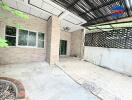 Outdoor patio with brick walls and overhead lattice structure