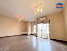 Spacious living room with wooden flooring and large windows