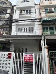 Front view of a multi-storey residential building with a gate