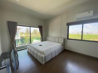 Spacious bedroom with large windows and a view