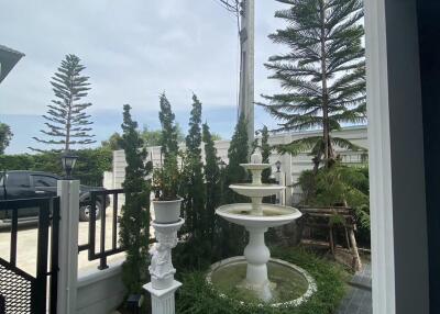 Front exterior area with decorative fountain and landscaping