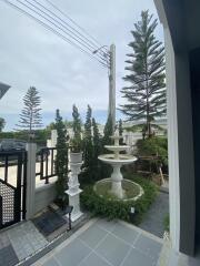 Front exterior area with decorative fountain and landscaping