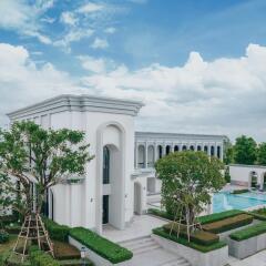 White modern building with large windows and a swimming pool