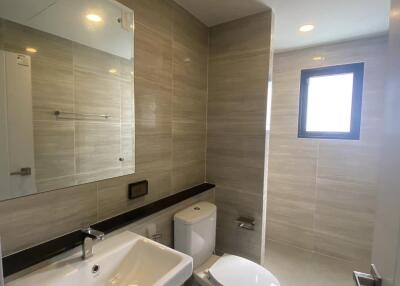 Modern bathroom with sink, toilet, and shower area