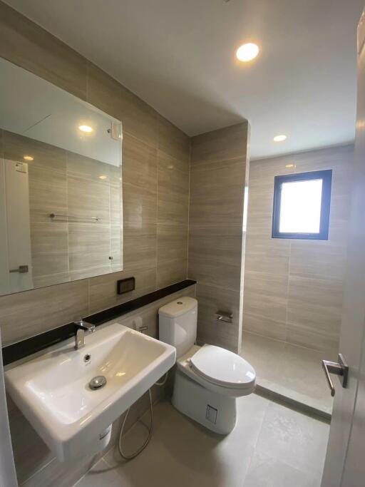 Modern bathroom with sink, toilet, and shower area