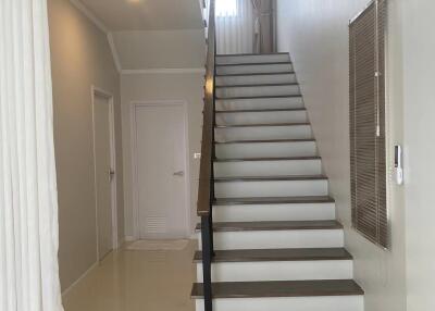 Staircase leading to upper floor with minimalist decor