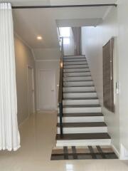 Staircase leading to upper floor with minimalist decor