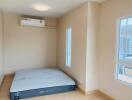 Bedroom with air conditioning and mattress