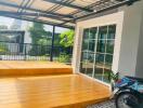 Spacious patio area with wooden flooring and a sliding glass door