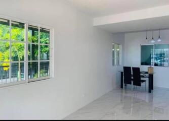 Spacious living area with modern dining table and large windows