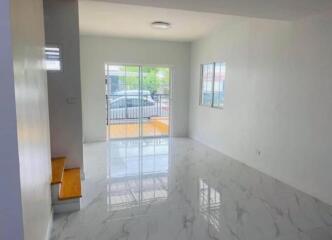 Bright and spacious living room with tiled floor and a large window