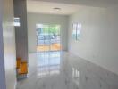 Bright and spacious living room with tiled floor and a large window