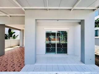 Front porch of a residential building with sliding glass doors