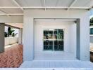 Front porch of a residential building with sliding glass doors