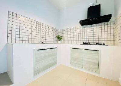 Modern kitchen with tiled backsplash and gas stove