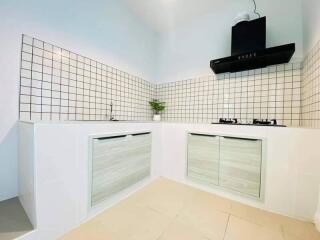 Modern kitchen with tiled backsplash and gas stove