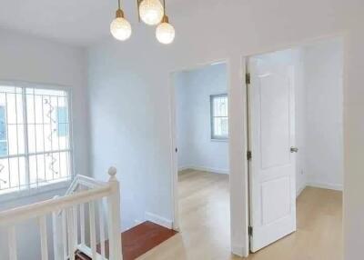 Bright hallway with chandelier and natural lighting