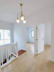 Bright hallway with chandelier and natural lighting