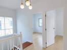 Bright hallway with chandelier and natural lighting