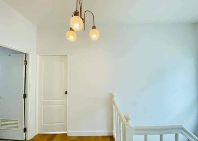 Hallway with pendant lights and white walls