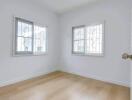 Bright bedroom with wooden flooring and windows