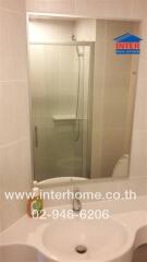 Bathroom with shower and mirror