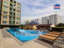 Modern apartment building with swimming pool and lounge chairs