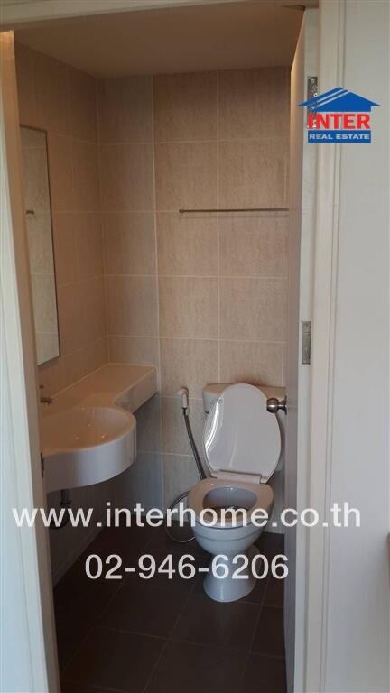 Compact bathroom with modern wall tiles and basic sanitary fixtures