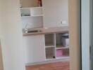 Modern kitchen with wooden flooring and built-in shelves