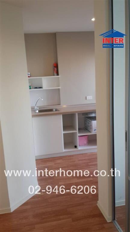 Modern kitchen with wooden flooring and built-in shelves