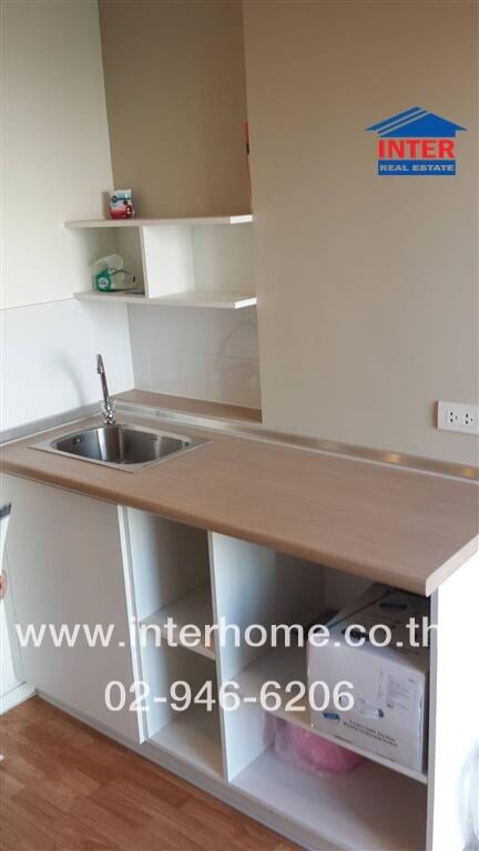 Small kitchen area with wooden countertops and open shelving