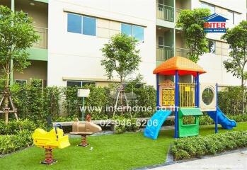 Outdoor play area with colorful playground equipment in a residential complex