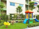 Outdoor play area with colorful playground equipment in a residential complex