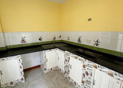 Small kitchen with yellow walls and decorative cabinets