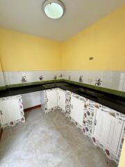 Small kitchen with yellow walls and decorative cabinets