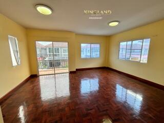 spacious living room with large windows and wooden flooring