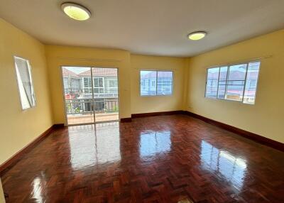 Spacious and well-lit living room with wooden flooring