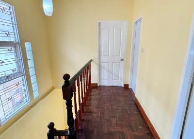 Bright hallway with wooden parquet flooring and large window