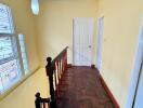 Bright hallway with wooden parquet flooring and large window