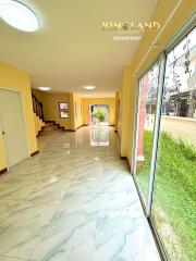 Spacious entry hallway with marble flooring and large windows