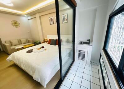 modern bedroom with attached balcony and amenities