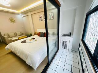 modern bedroom with attached balcony and amenities