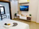 Modern bedroom with wall-mounted TV and air conditioning