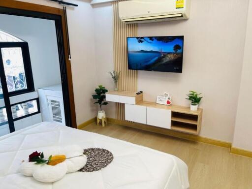 Modern bedroom with wall-mounted TV and air conditioning