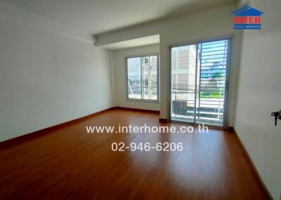 Bright living room with wooden flooring and large windows