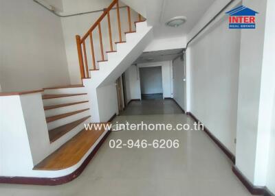 Interior view of the property showcasing staircase and hallway