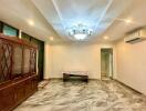 Spacious living room with marble floors and chandelier