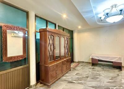 Living room with large cabinet and chandelier