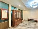 Living room with large cabinet and chandelier