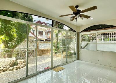 Bright and spacious living room with large windows overlooking garden